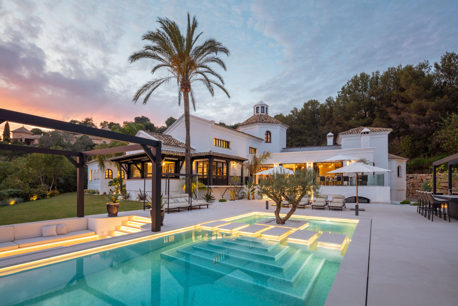 Villa på Costa del Sol i skumring, med opplyst basseng og terrasse